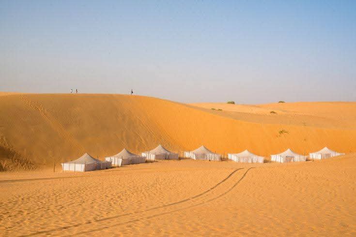 Desert dune camp at sunset