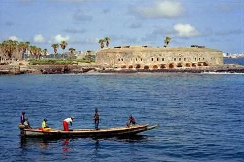 Fishing boat passing a coastal fort