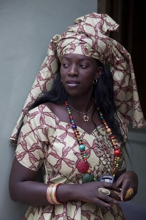 Woman with traditional printed headscarf and beads