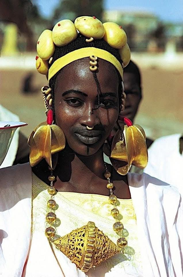 Woman wearing traditional Fulani gold jewelry