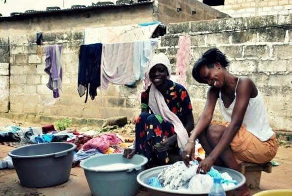 Two women sharing a moment during laundry, neighborhood life
