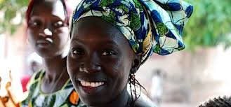 Smiling woman with traditional blue headwrap